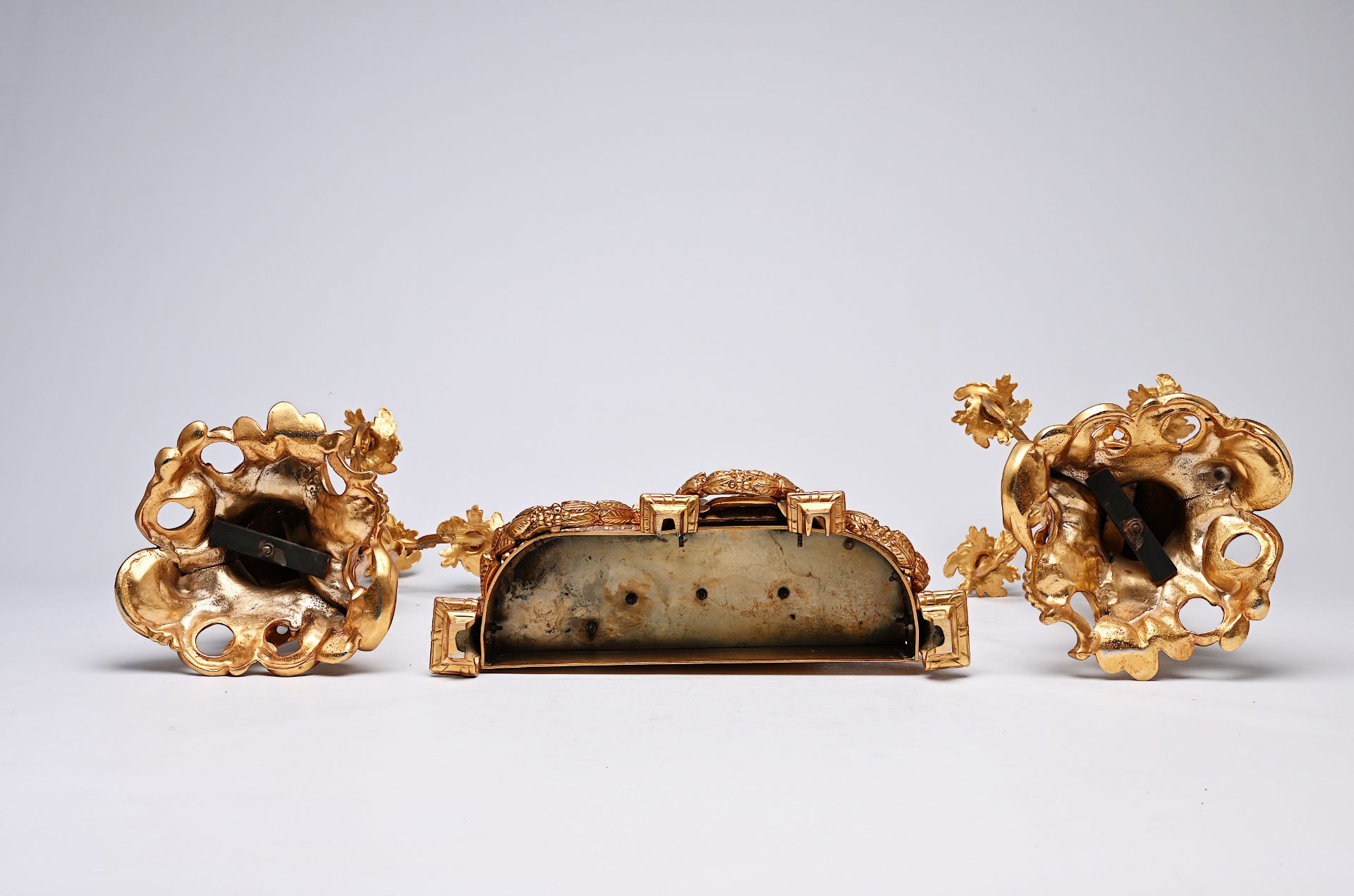 A French three-piece partly gilt metal clock garniture with putti, 20th C. - Image 10 of 11