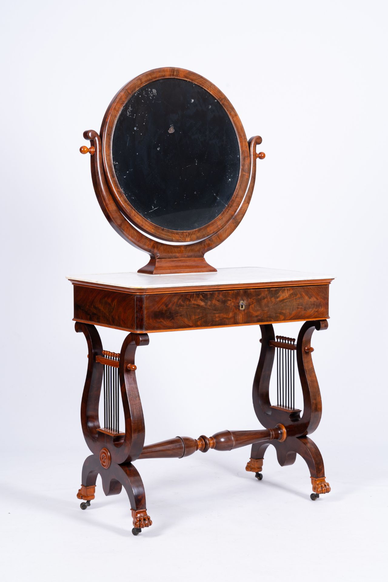 A mahogany toiletry table with lyre harp shaped base and marble top, 19th C.