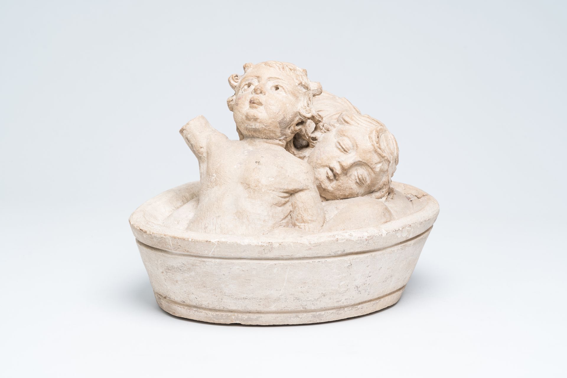 A French limestone group depicting the three Saint Nicholas children in a tub, 16th C.