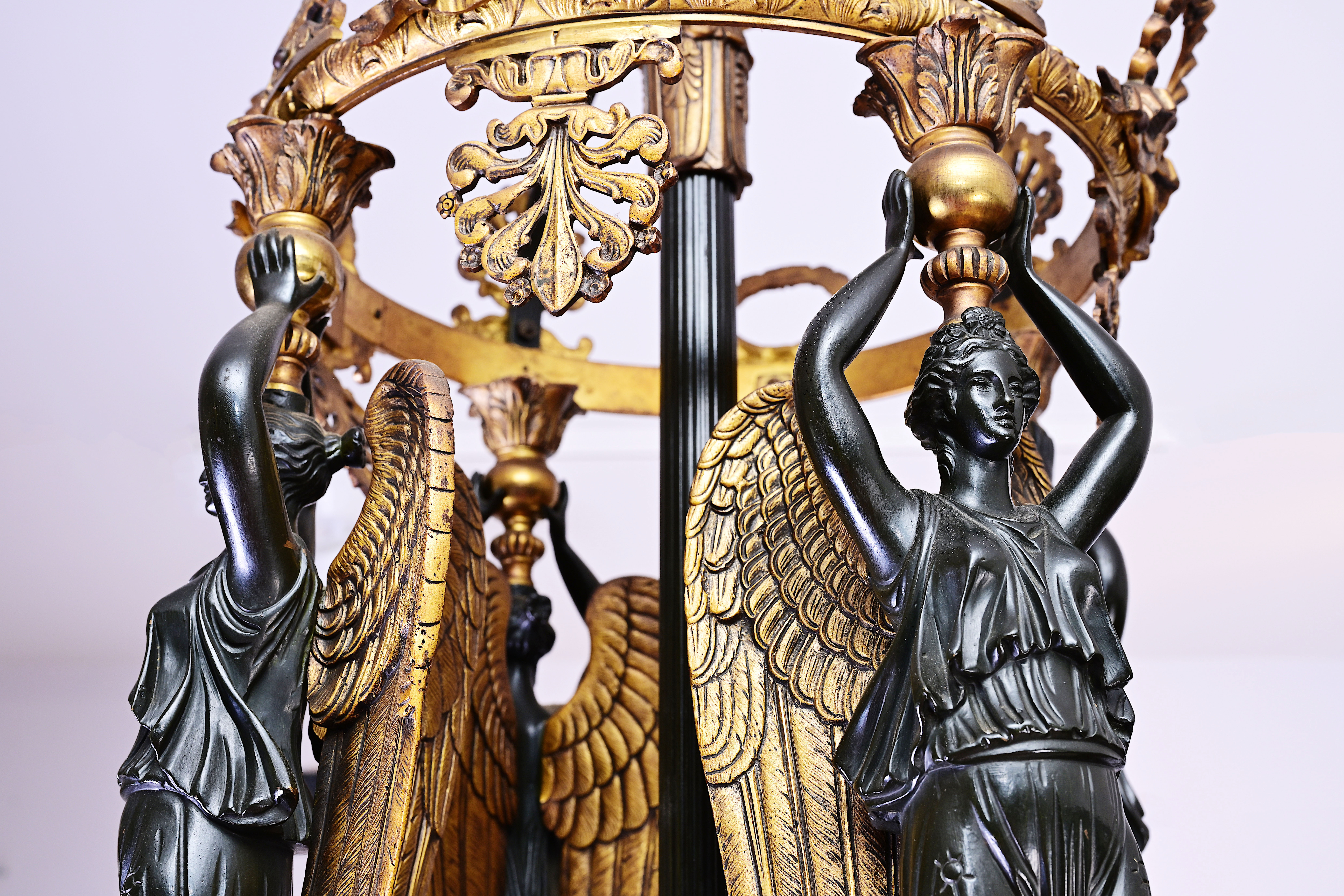 A French patinated and gilt bronze Empire style twelve-light 'caryatids' chandelier, 19th C. - Image 4 of 7
