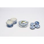 A Dutch Delft blue and white butter tub, an oil and vinegar holder and a spice dish with floral desi