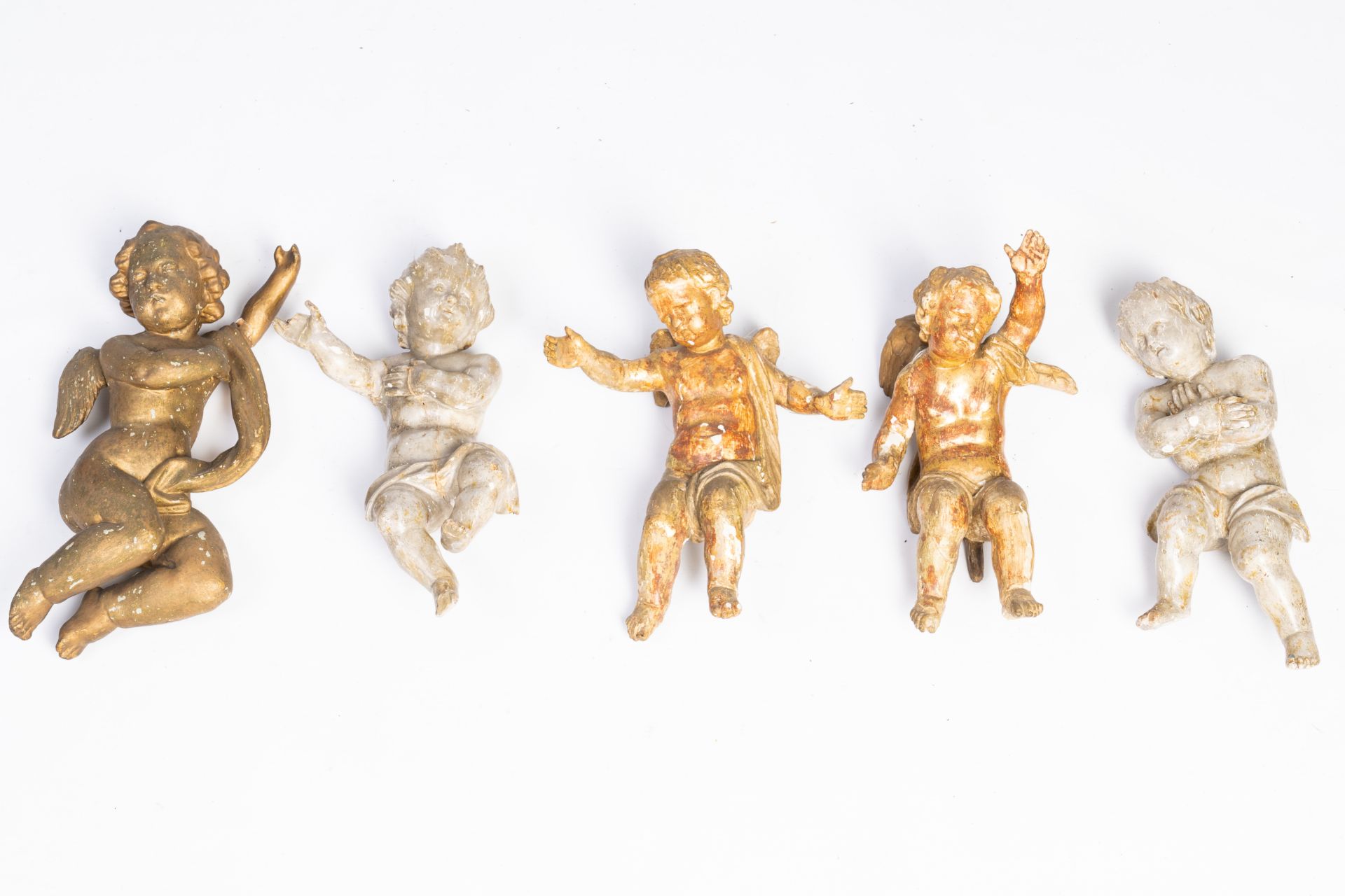 Five gilt and patinated carved wood angels, 18th/19th C.