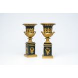 A pair of French patinated and gilt bronze 'Campana' urns in the style of Thomire, 19th/20th C.