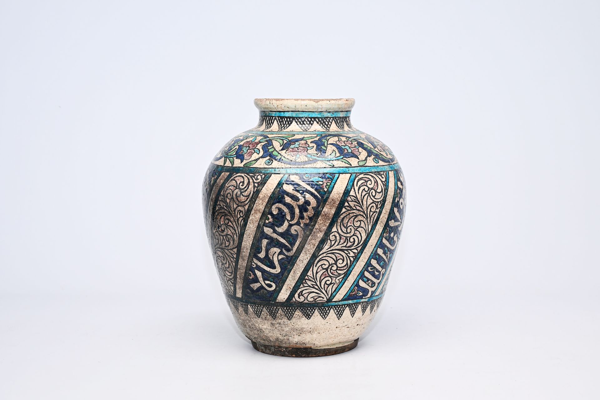 A polychrome pottery jar with floral and calligraphic design, Iran, 19th C.