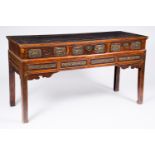 A Chinese wood wall console with partly gilt relief design, 19th/20th C.