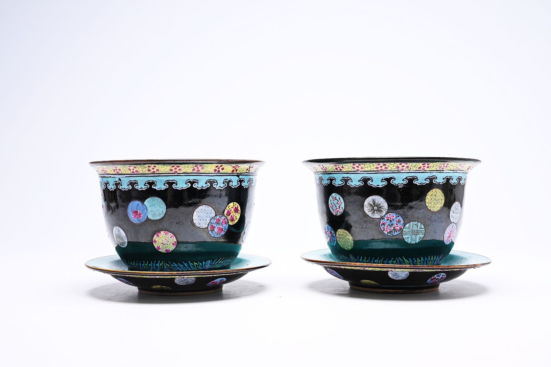 A pair of Chinese famille rose black ground jardinieres on stand with floral design, Kangxi mark, 19