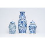 A Chinese blue and white 'lotus scroll' vase and a pair of 'peony scroll' vases, 19th C.