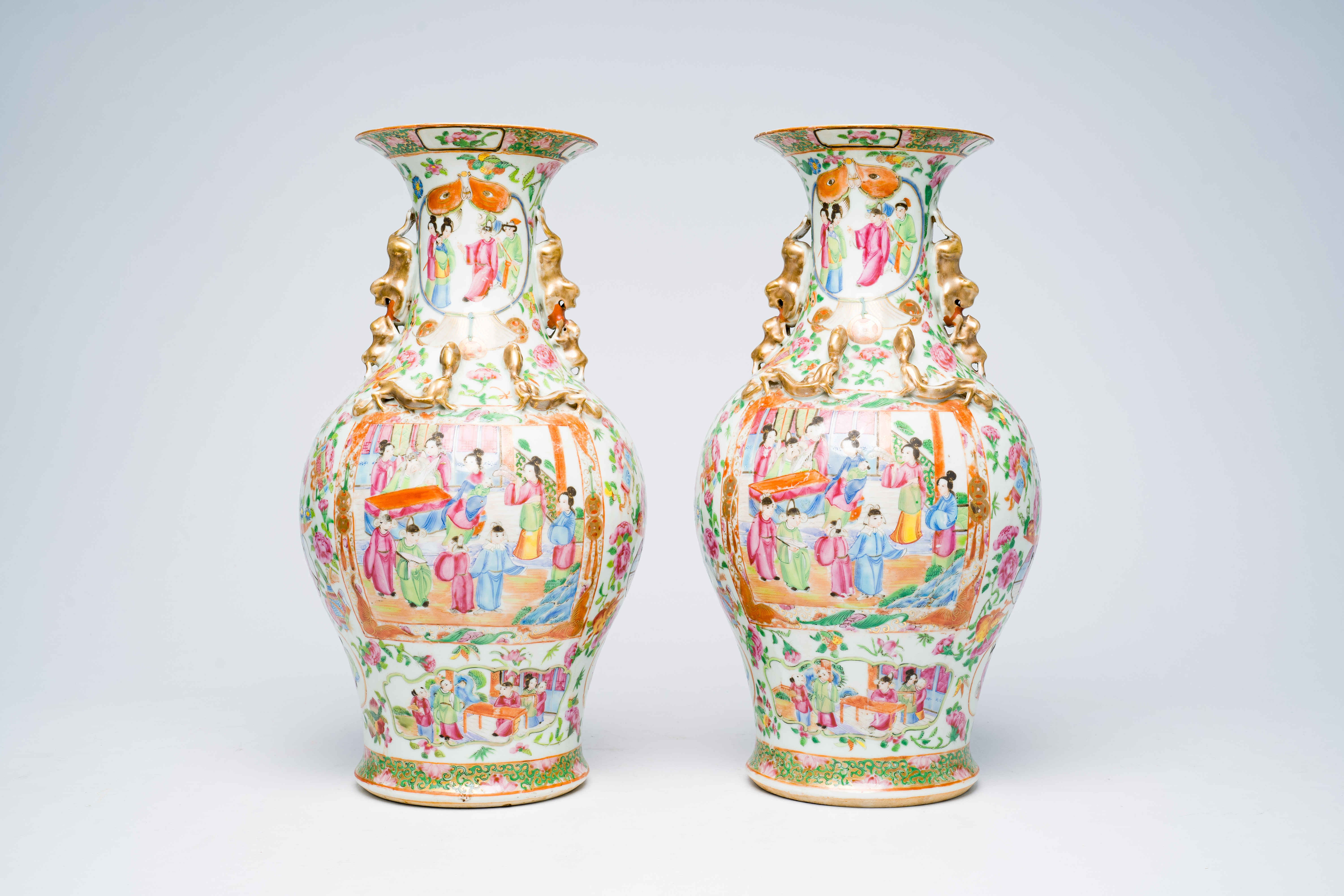 A pair of Chinese Canton famille rose vases with palace scenes, floral design and antiquities, 19th