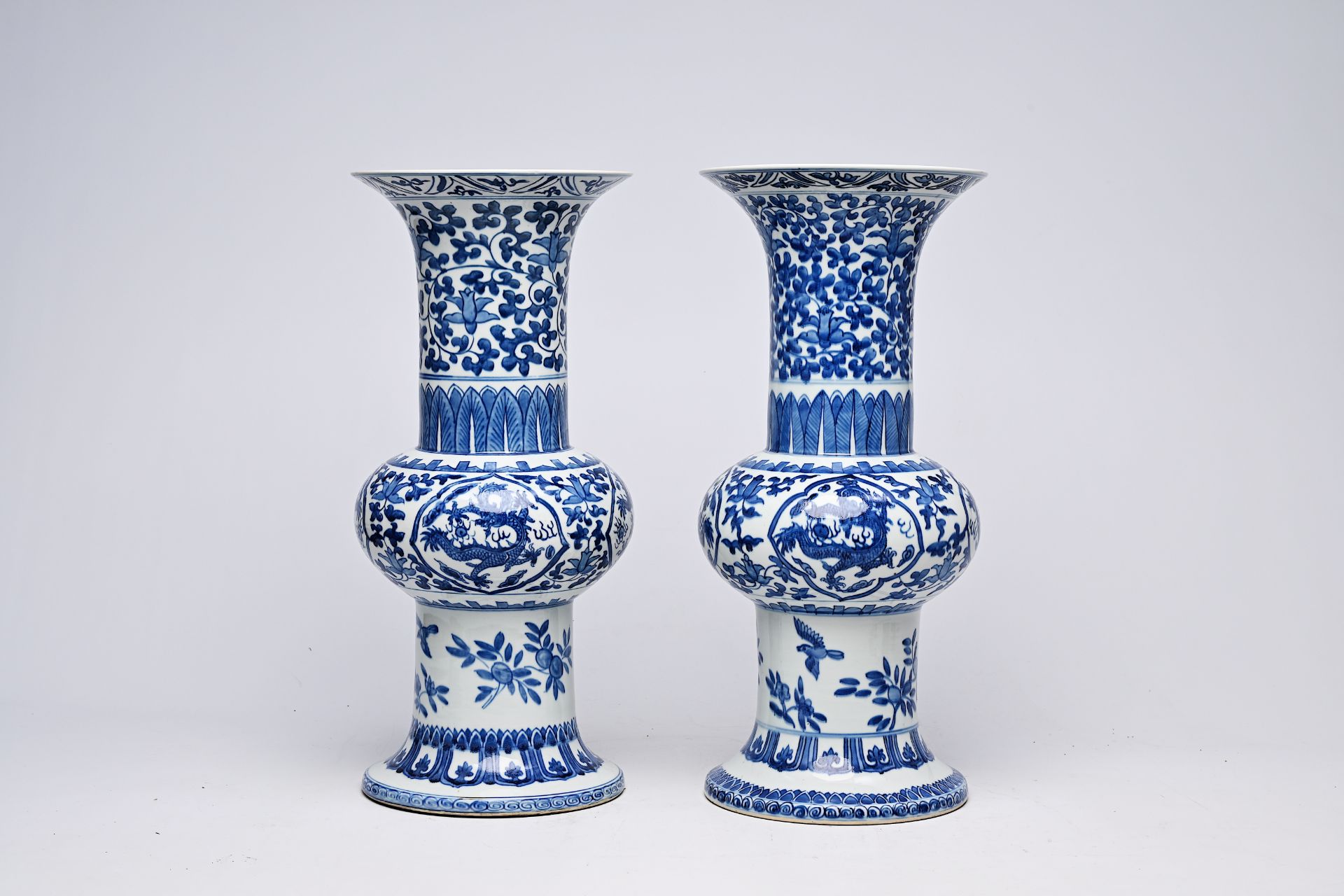 A pair of Chinese blue and white 'gu' vases with dragons and floral design, Qianlong mark, Republic, - Image 2 of 22