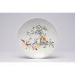 A Chinese famille rose dish with playing boys in a garden, Qianlong mark, first half 20th C.