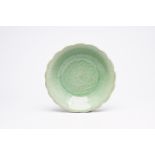 A Chinese lotus-shaped celadon dish with incised floral design, probably Longquan, Ming