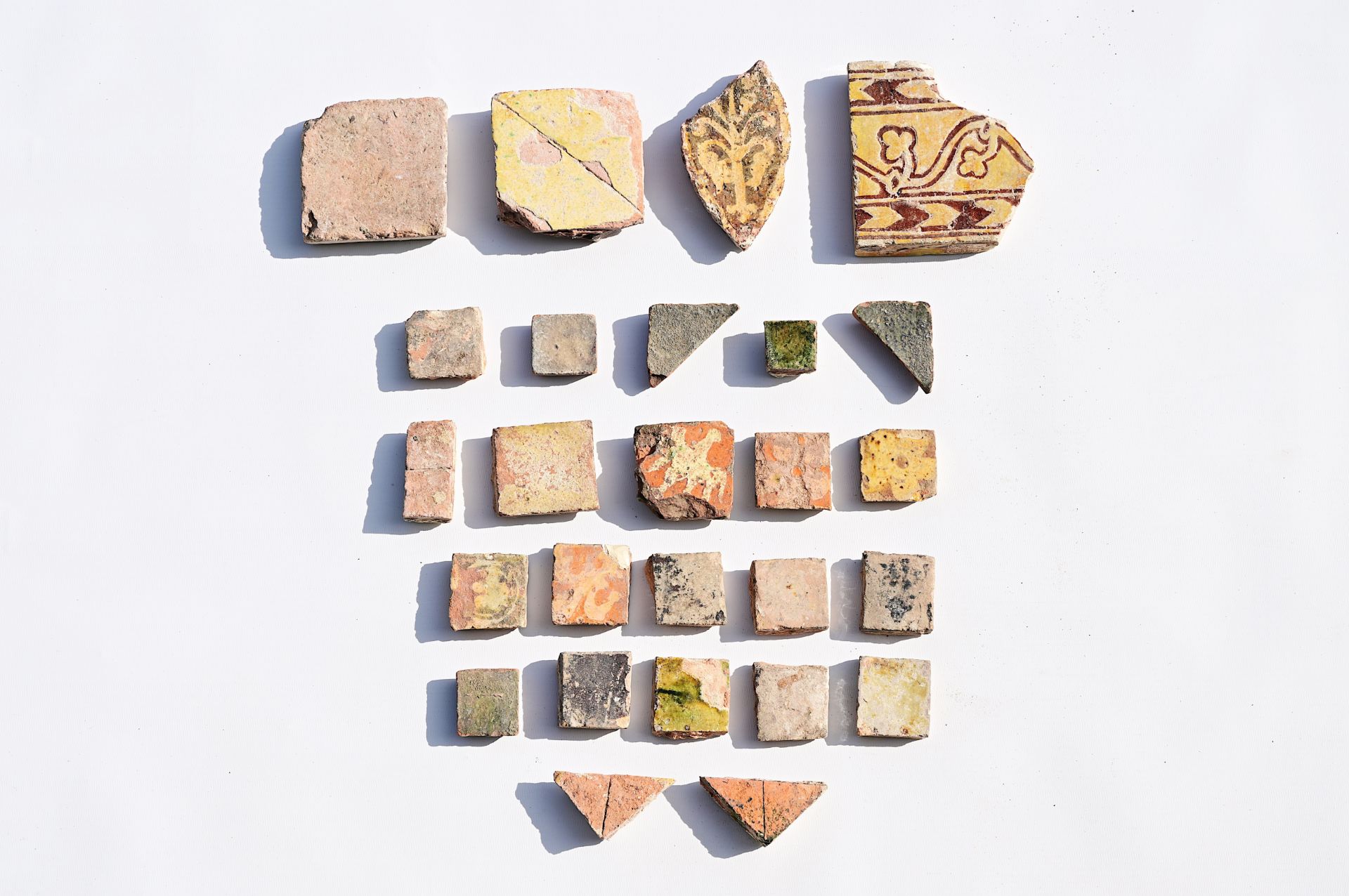 A varied collection of medieval tile fragments, 12th/16th C.