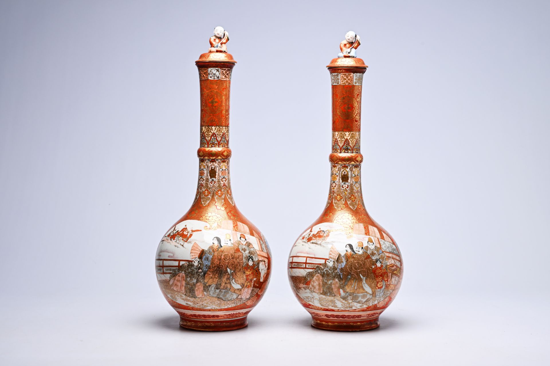 A pair of Japanese Kutani bottle-shaped vases and covers with a coot among blossoming branches and f