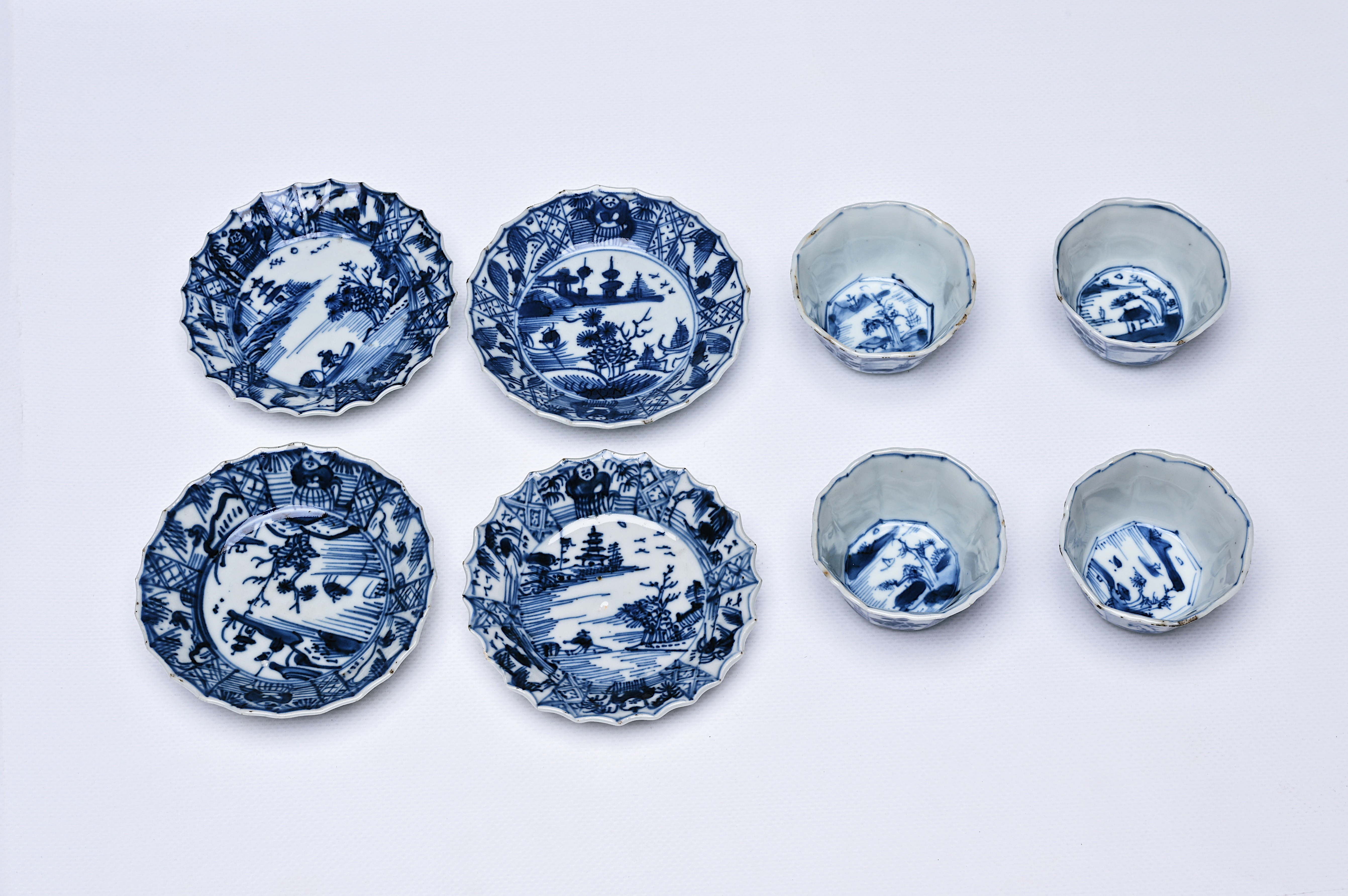 Four Chinese blue and white cups and saucers with floral design and landscapes, Kangxi - Image 11 of 12