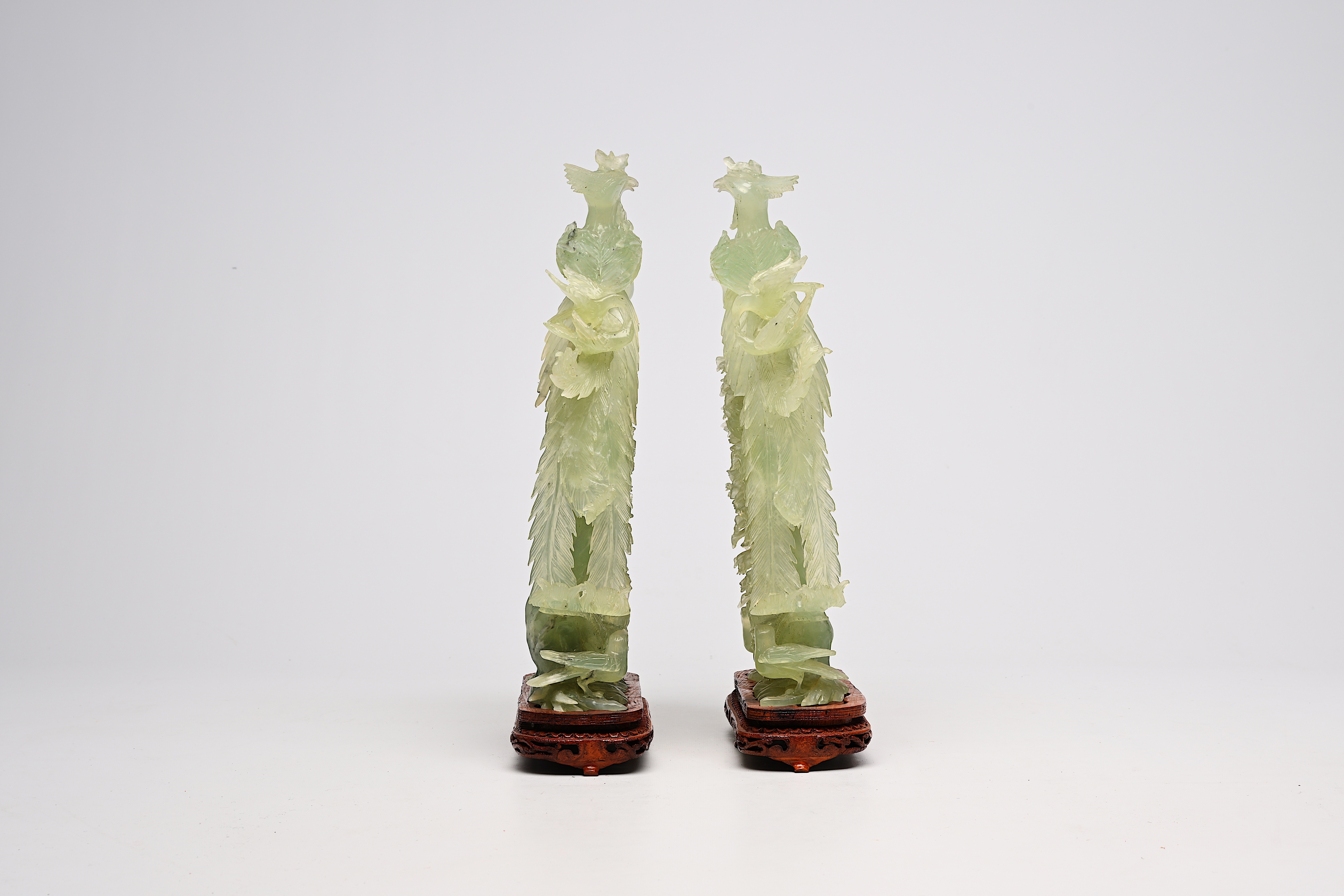 A pair of large Chinese carved jadeite groups with a phoenix among blossoming branches, 20th C. - Image 3 of 6