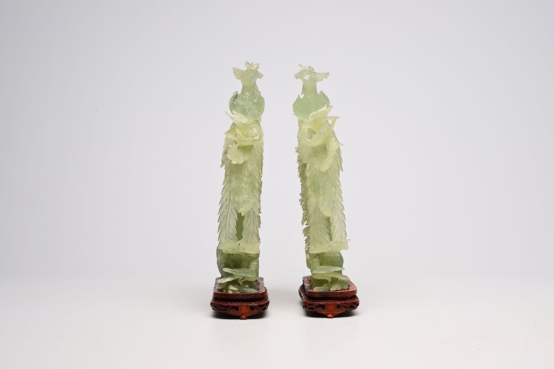 A pair of large Chinese carved jadeite groups with a phoenix among blossoming branches, 20th C. - Image 3 of 6