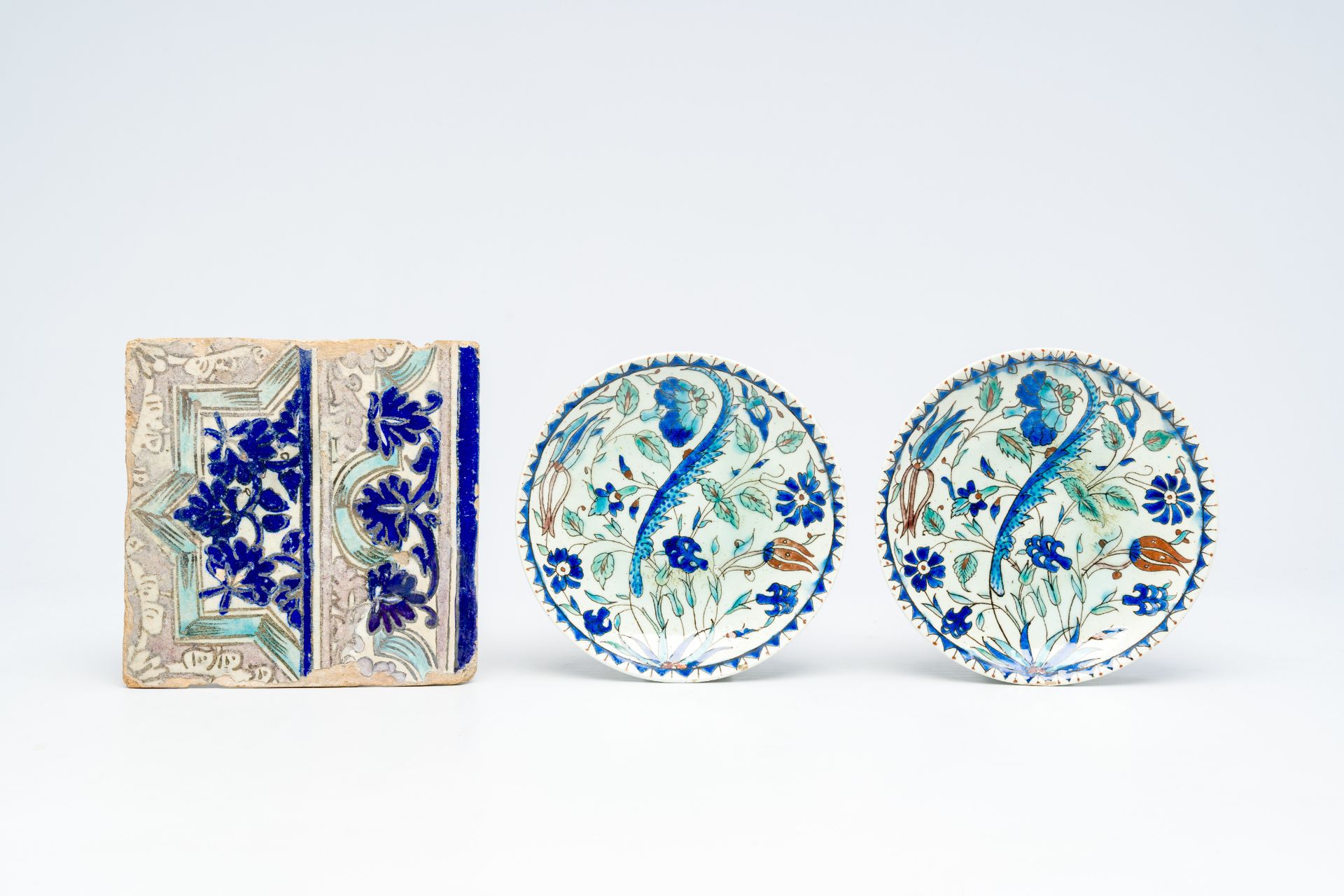 A pair of polychrome Kutahya Isnik style plates and an Iranian tile, 19th C. - Image 2 of 3