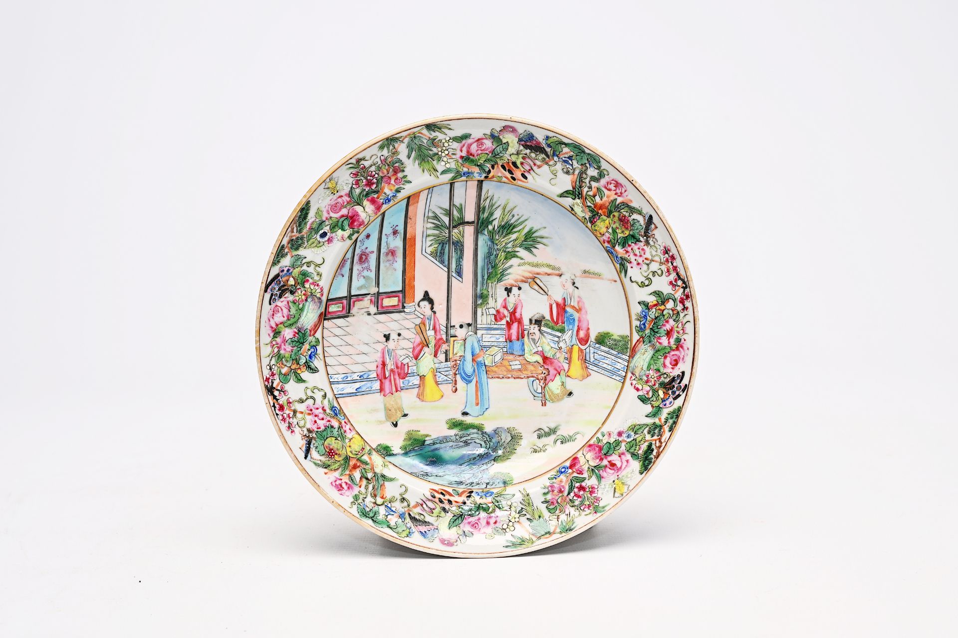 A fine Chinese Canton famille rose plate with a scholar at his desk, 19th C.