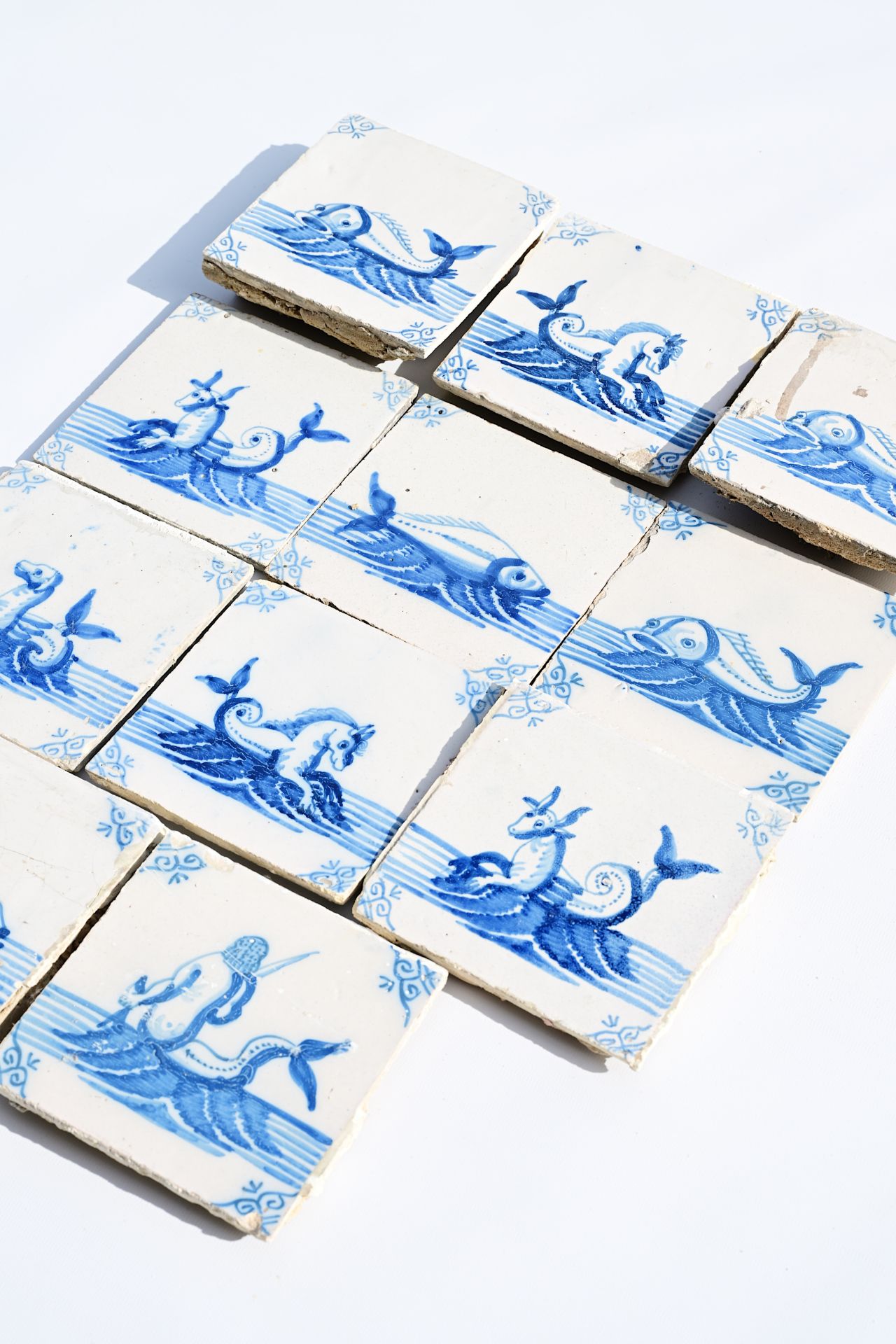 Eleven Dutch Delft blue and white 'sea monster' tiles, 19th C. - Image 3 of 3