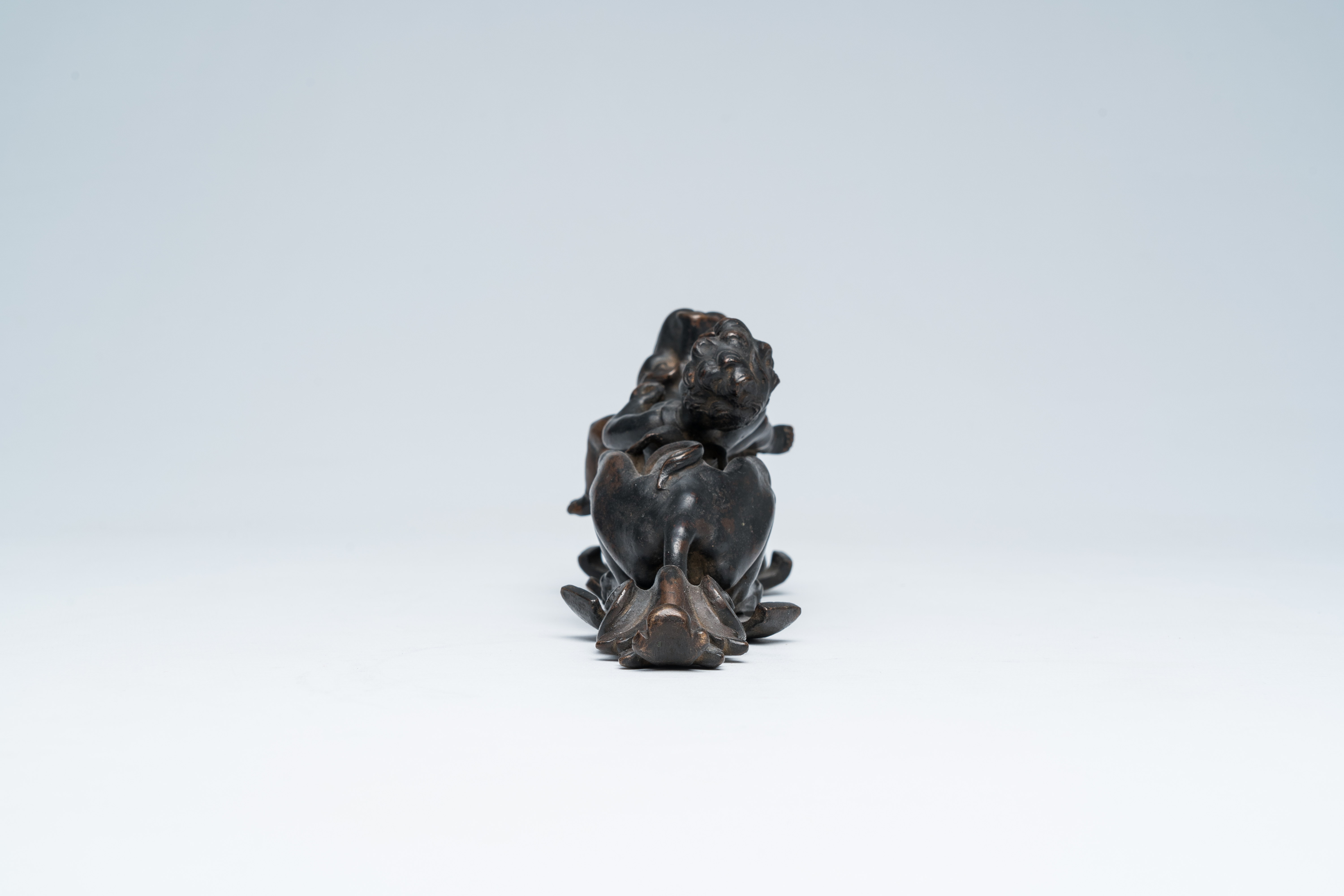 A Flemish patinated bronze door knocker with a jolly putto on a lion, presumably Antwerp, early 18th - Image 3 of 8