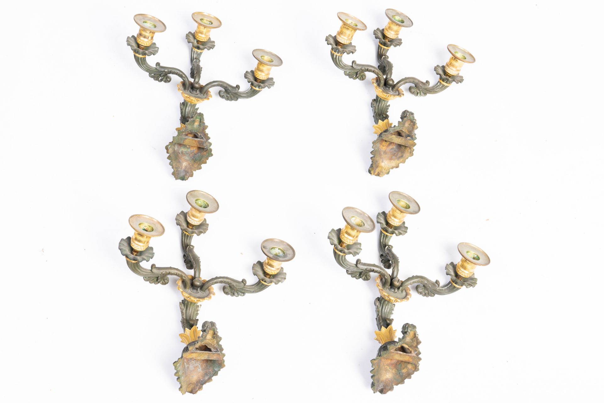 Two pairs of French Empire style gilt and patinated bronze three-armed wall lighting appliques, 19th