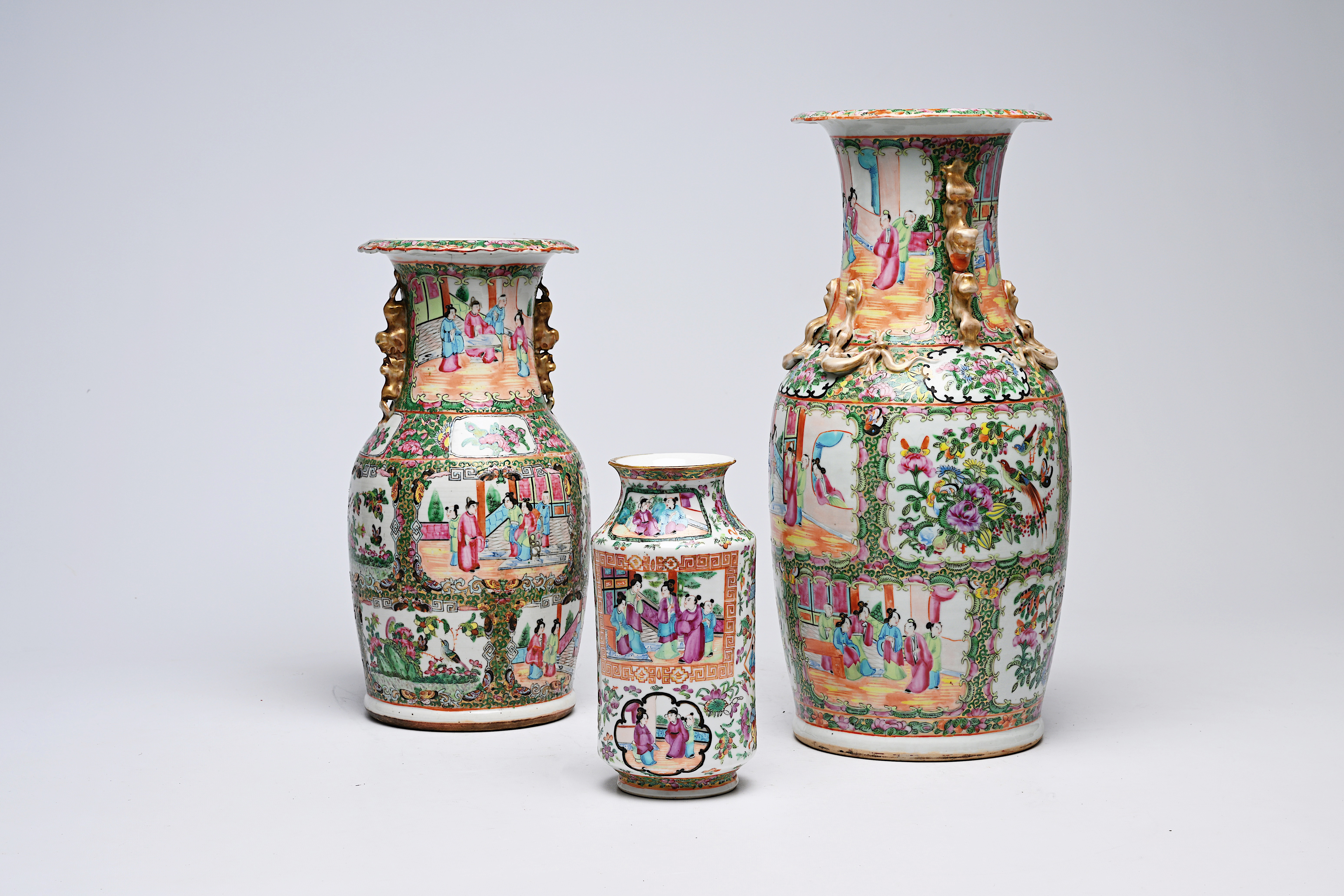 Three Chinese Canton famille rose vases with palace scenes and floral design, 19th C.