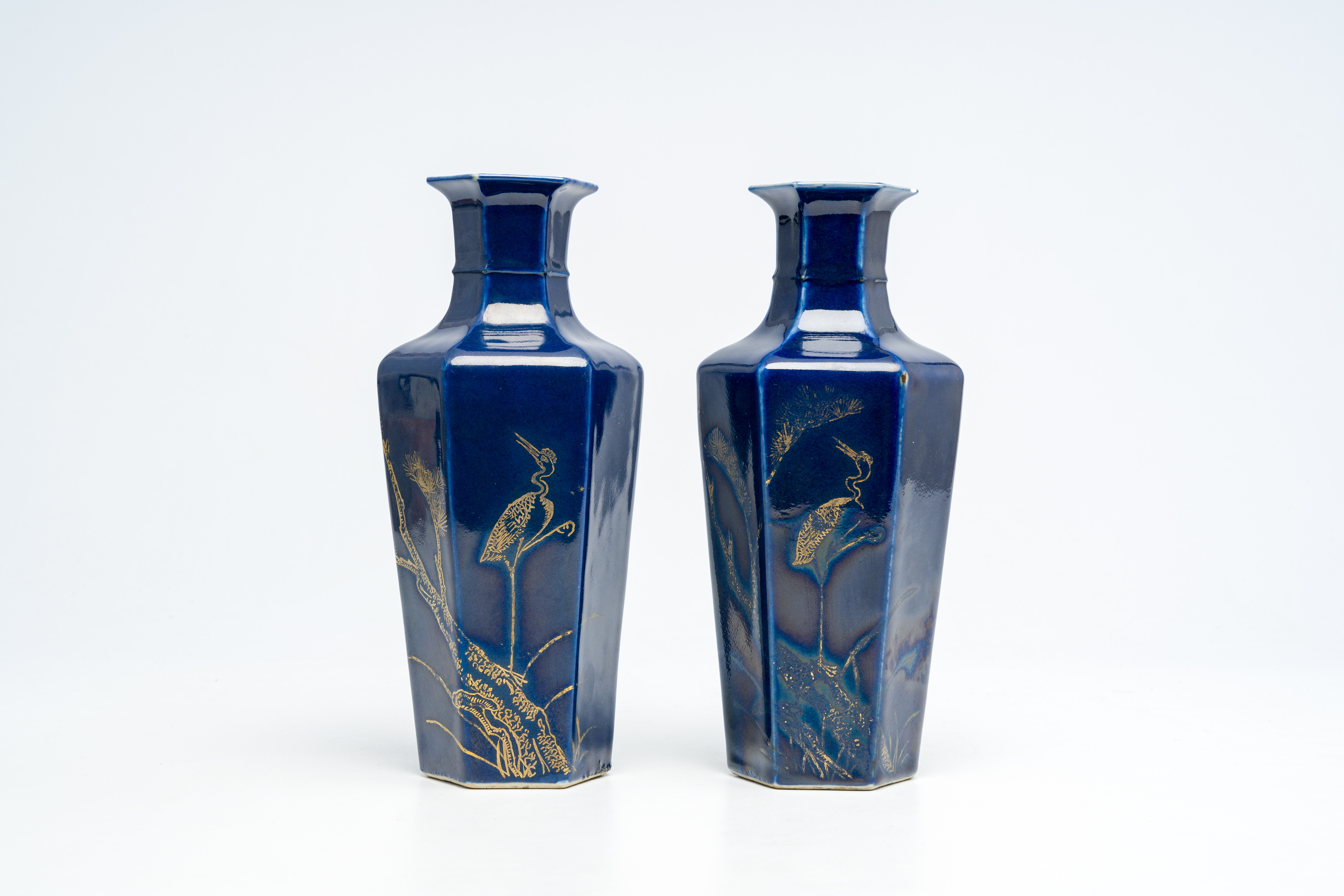 A pair of hexagonal Chinese monochrome blue-glazed gilt-decorated vases with a crane on a branch, 19