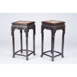 A pair of square Chinese reticulated hardwood stands with marble tops, 19th C.