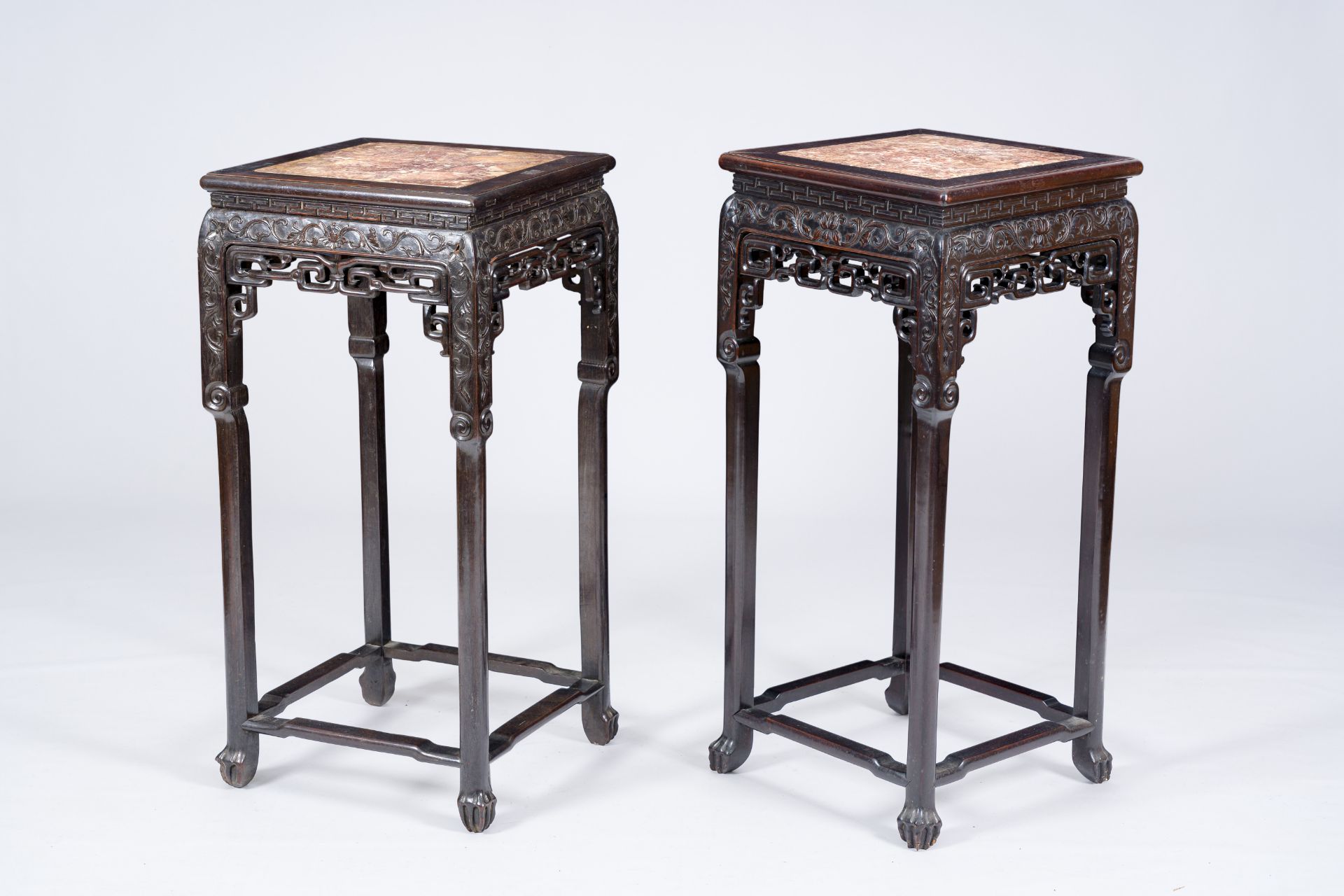 A pair of square Chinese reticulated hardwood stands with marble tops, 19th C.