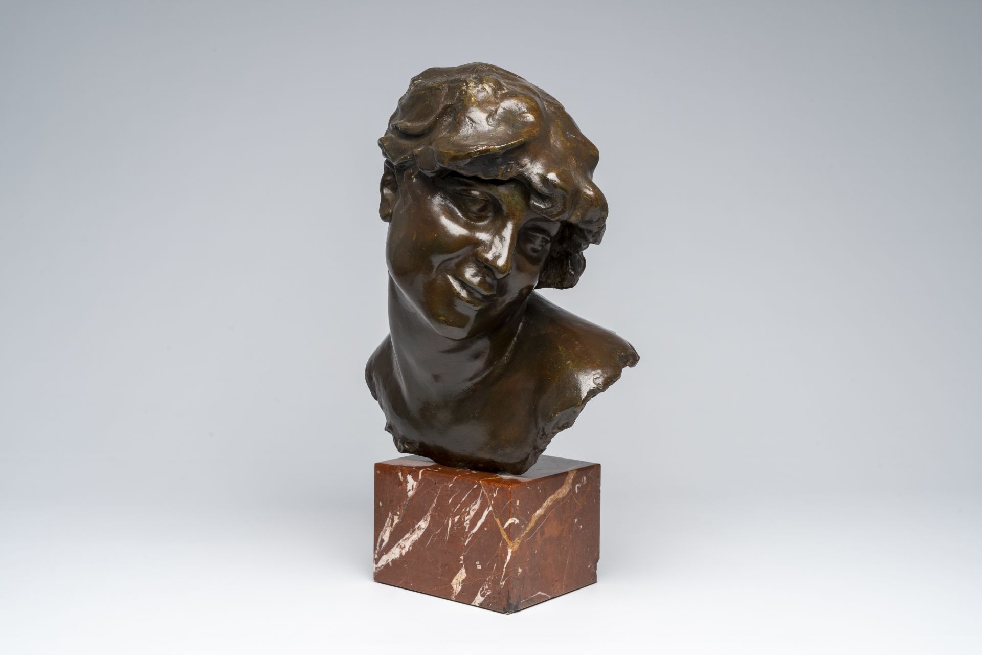 Jef Lambeaux (1852-1908, in the manner of): Bust of a lady, brown patinated bronze on a red marble b