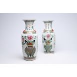 A pair of Chinese famille rose 'flower basket' vases, 19th C.