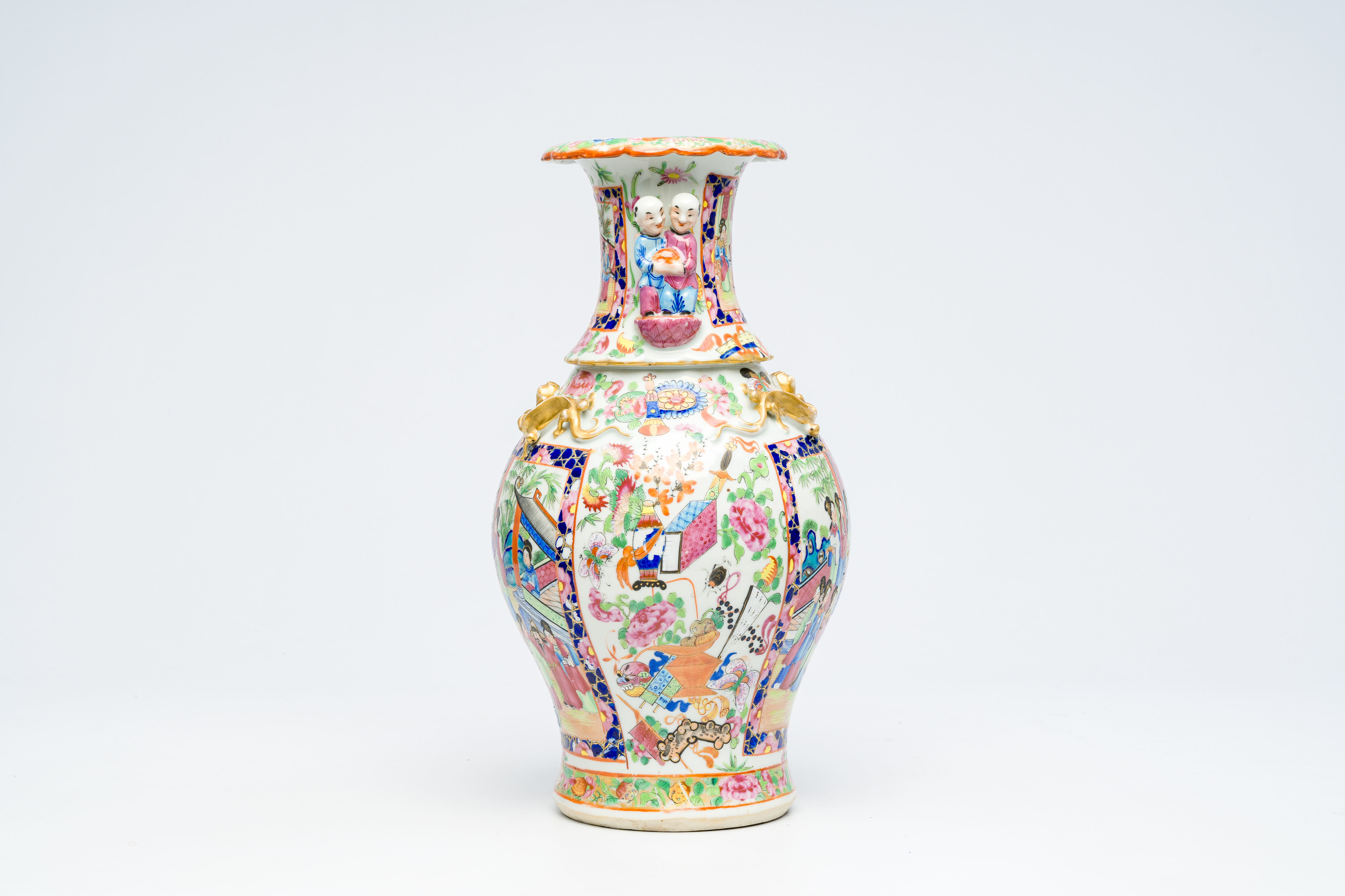 A Chinese Canton famille rose vase with palace scenes and the Hehe Er Xian twins in relief, 19th C. - Image 2 of 6