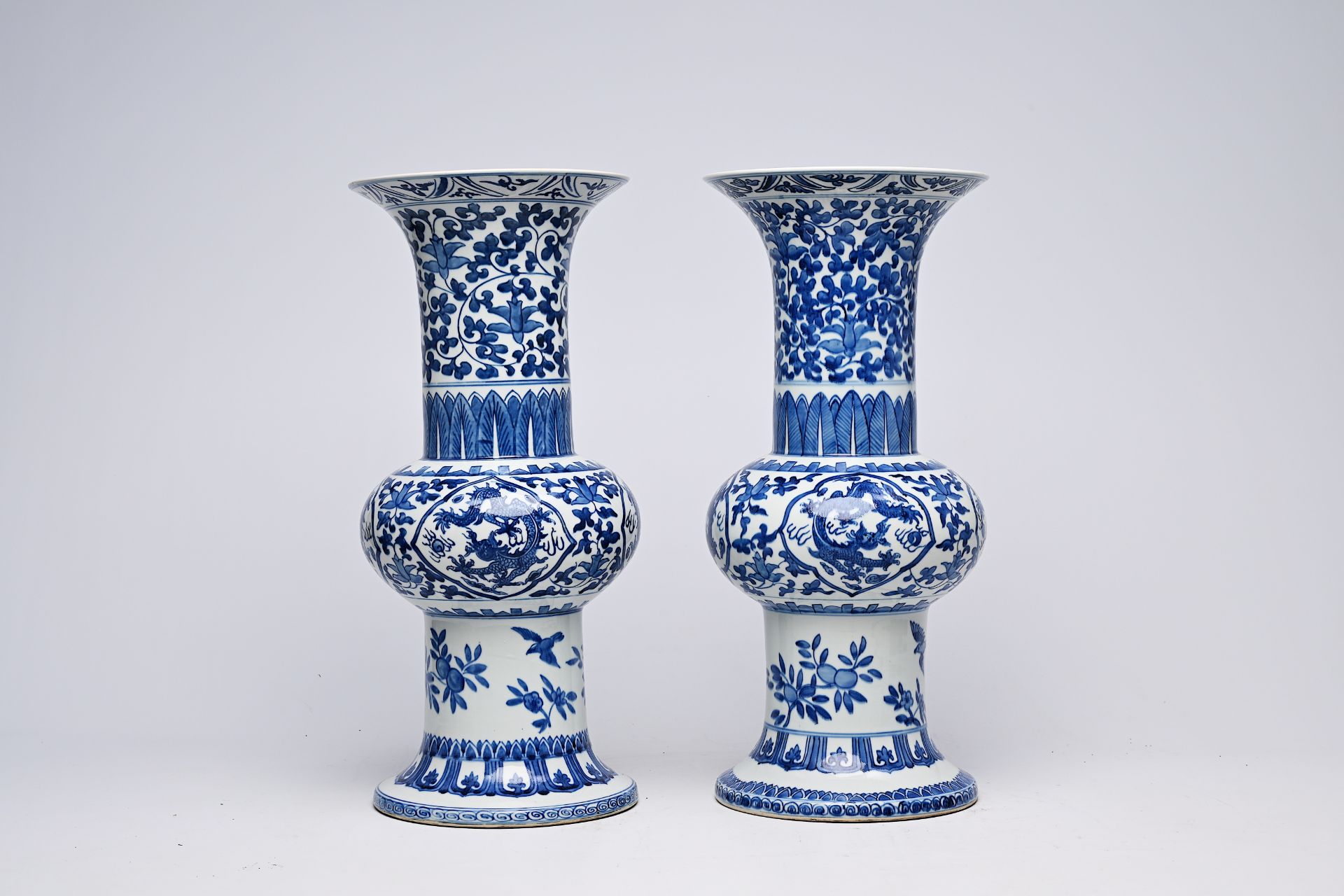 A pair of Chinese blue and white 'gu' vases with dragons and floral design, Qianlong mark, Republic, - Image 3 of 22