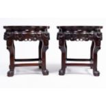 A pair of Chinese reticulated hardwood stands with marble tops, 20th C.