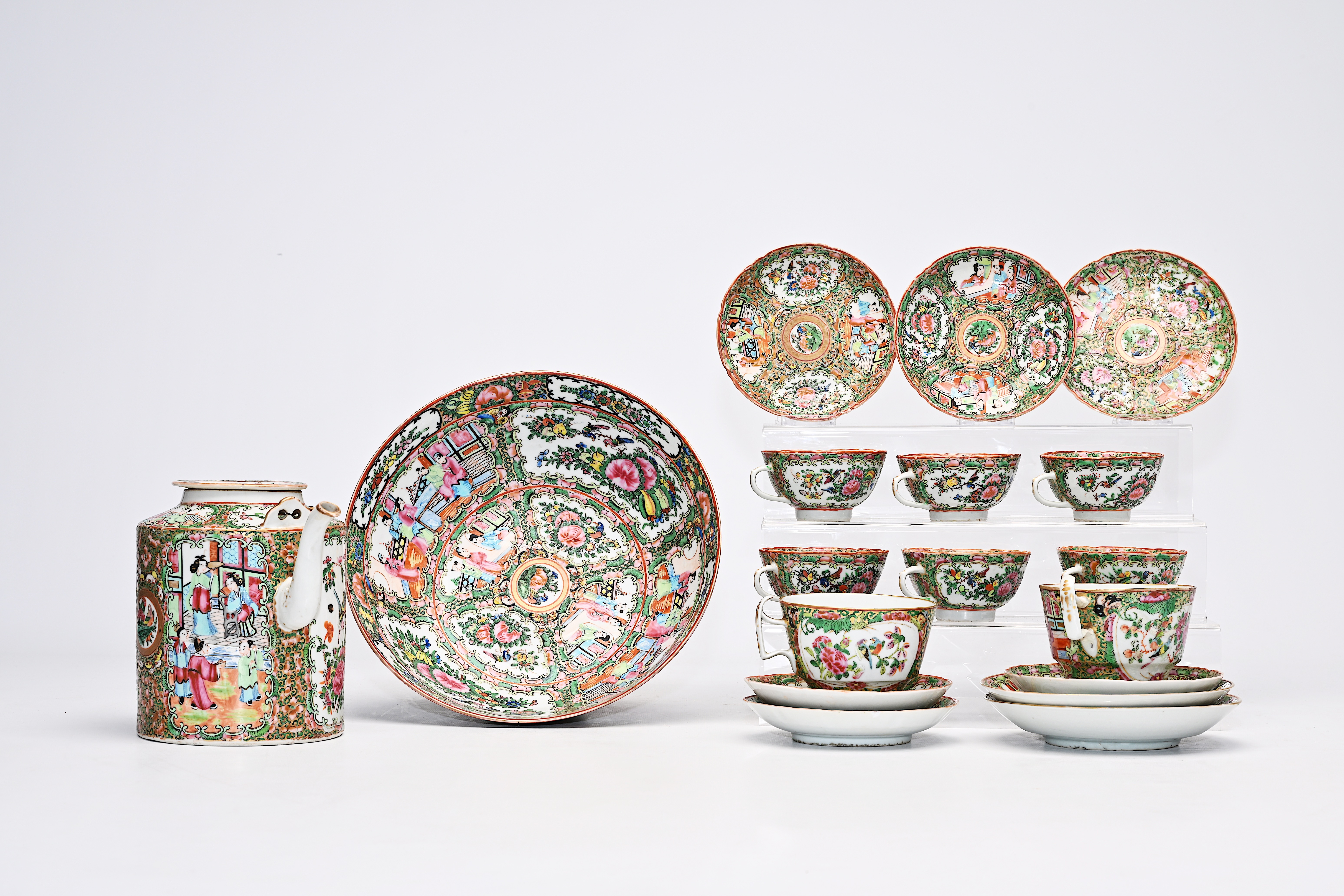 A Chinese Canton famille rose seventeen-part tea set and a bowl with palace scenes and floral design