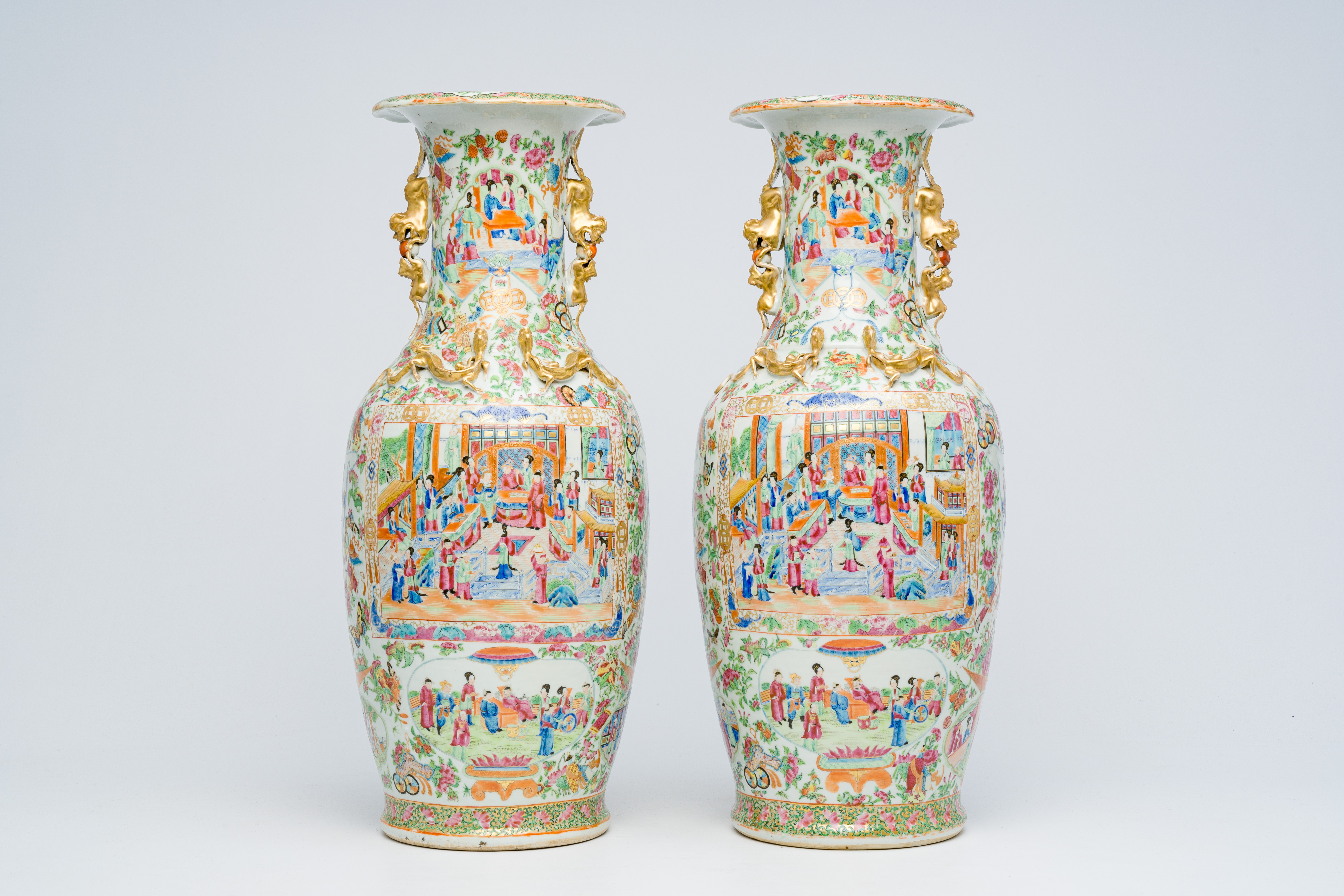 A pair of Chinese Canton famille rose vases with animated scenes, auspicious symbols and butterflies