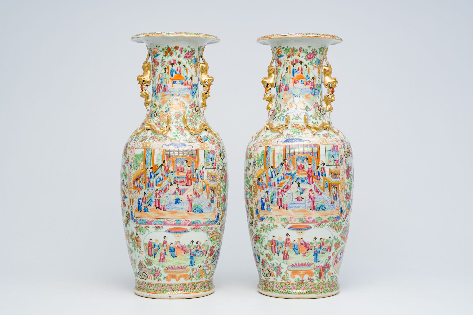 A pair of Chinese Canton famille rose vases with animated scenes, auspicious symbols and butterflies