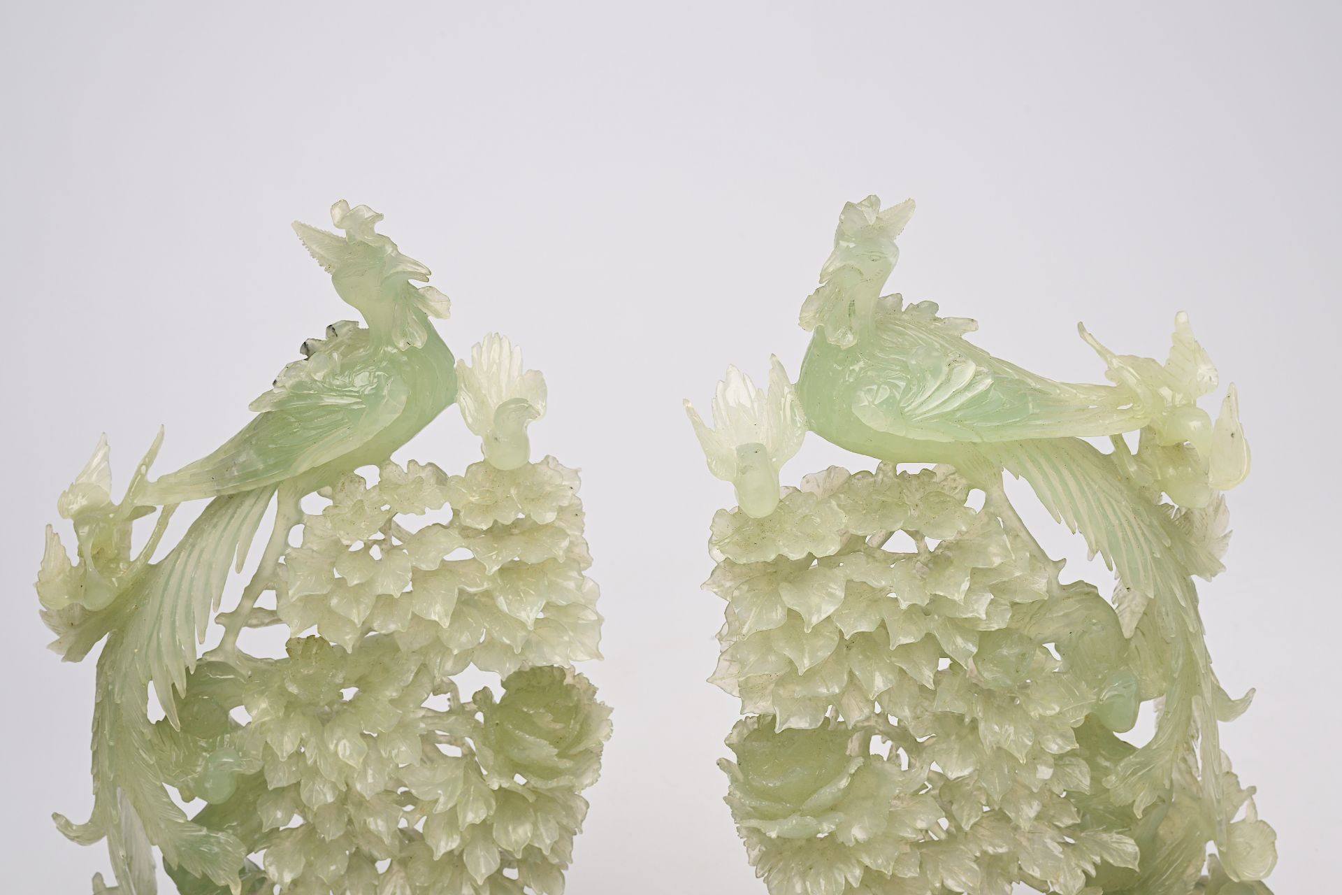 A pair of large Chinese carved jadeite groups with a phoenix among blossoming branches, 20th C. - Image 2 of 6