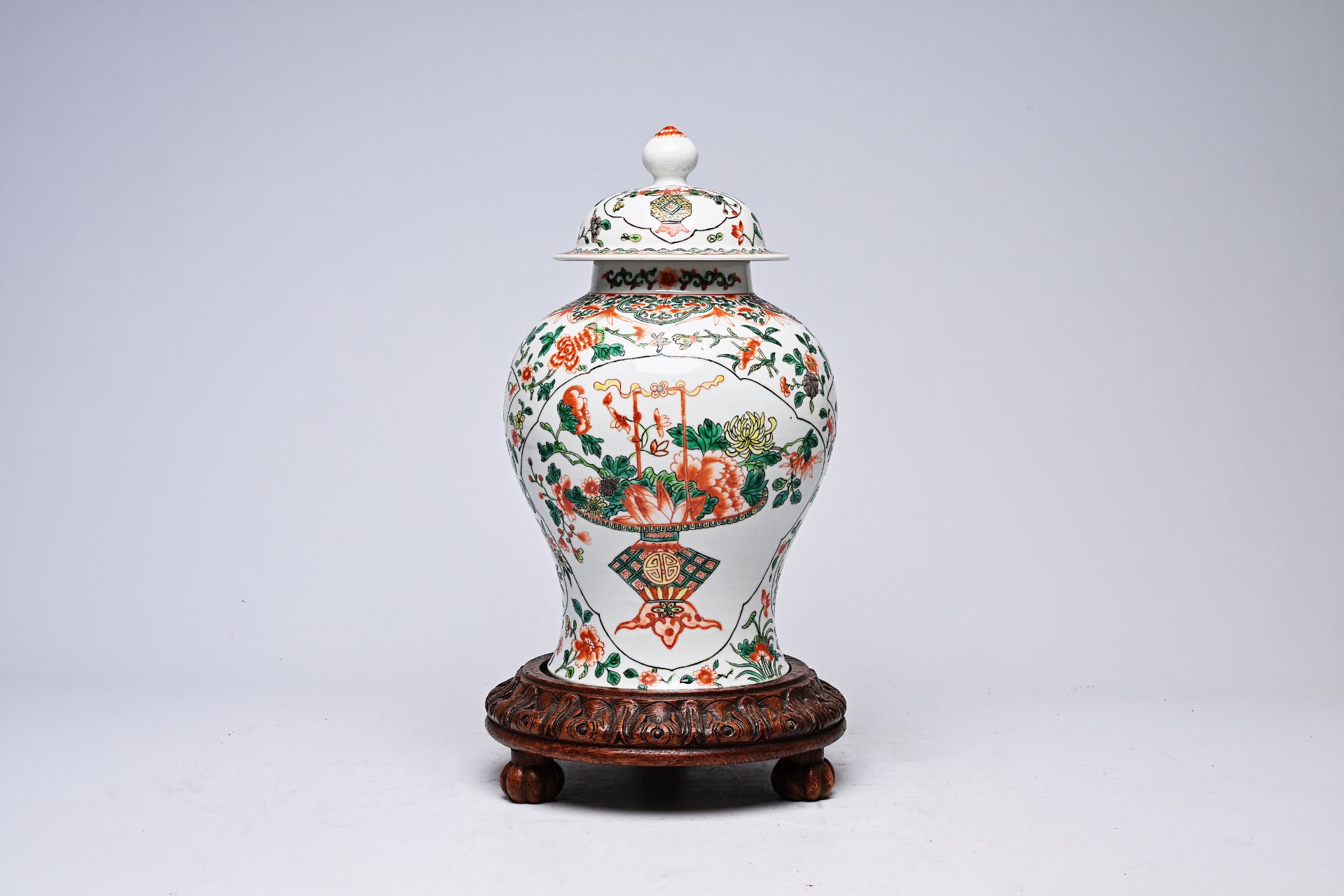 A Chinese famille verte 'flower basket' vase and cover, Kangxi mark, 19th C.