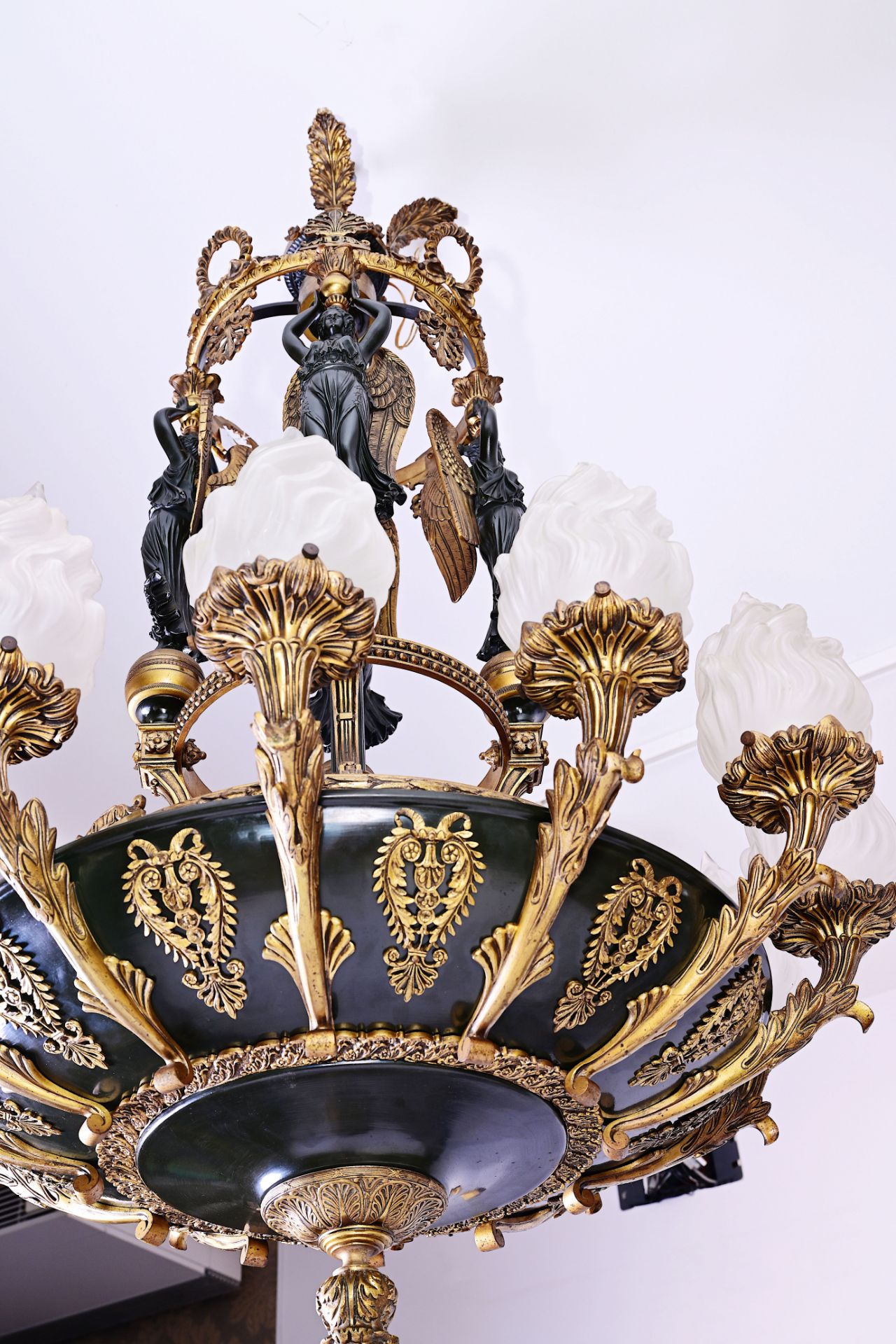 A French patinated and gilt bronze Empire style twelve-light 'caryatids' chandelier, 19th C. - Image 3 of 7