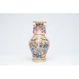 A Chinese Canton famille rose vase with palace scenes and the Hehe Er Xian twins in relief, 19th C.