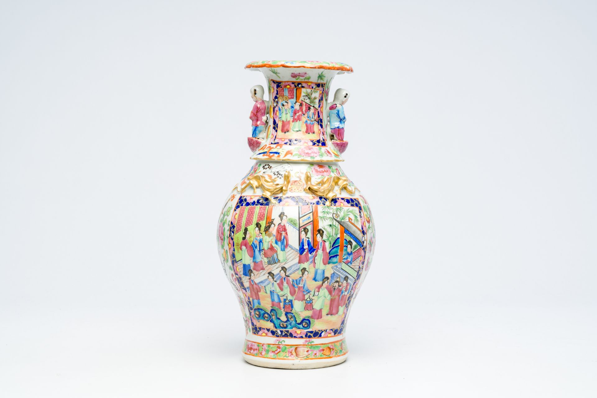 A Chinese Canton famille rose vase with palace scenes and the Hehe Er Xian twins in relief, 19th C.