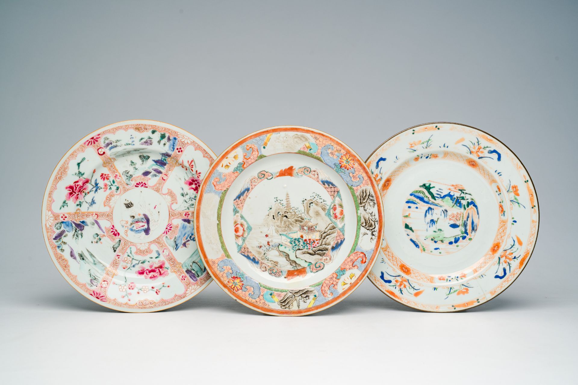 Three Chinese famille rose and famille verte 'landscape' plates, Qianlong