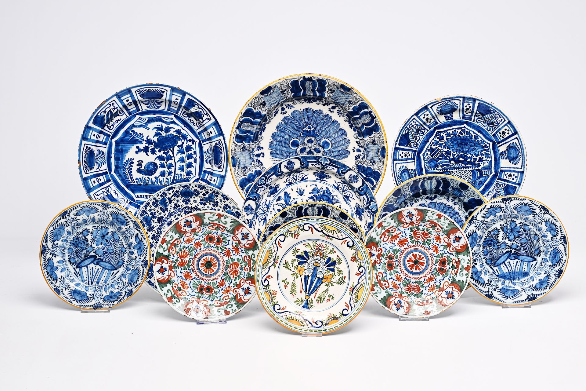 Twelve Dutch Delft blue and white and polychrome plates and dishes, 18th C.