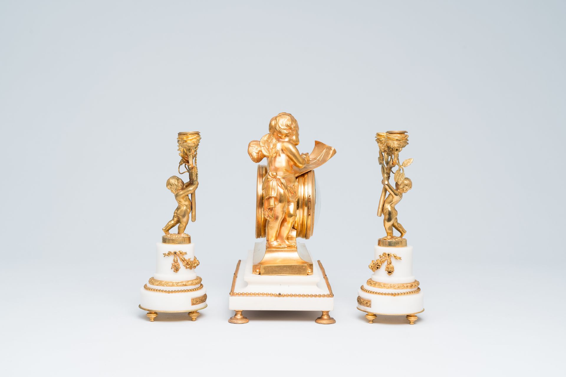 A French gilt bronze mounted white marble three-piece clock garniture with putti, 19th C. - Image 3 of 34