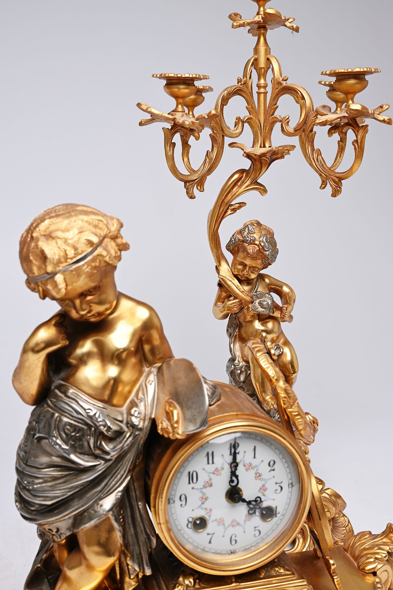 A French three-piece partly gilt metal clock garniture with putti, 20th C. - Image 7 of 11