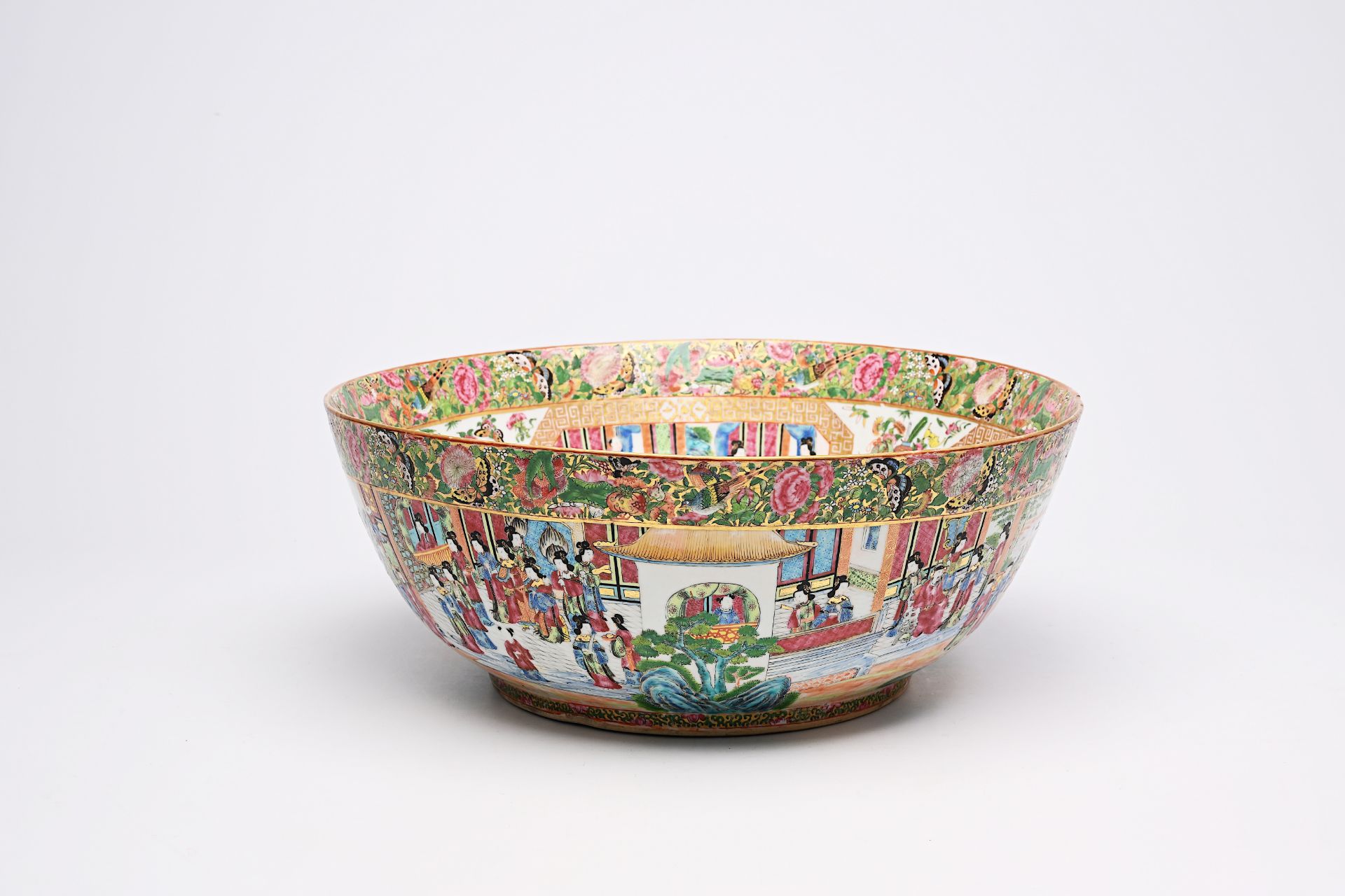 A large Chinese Canton famille rose bowl with floral design and palace scenes, 19th C.
