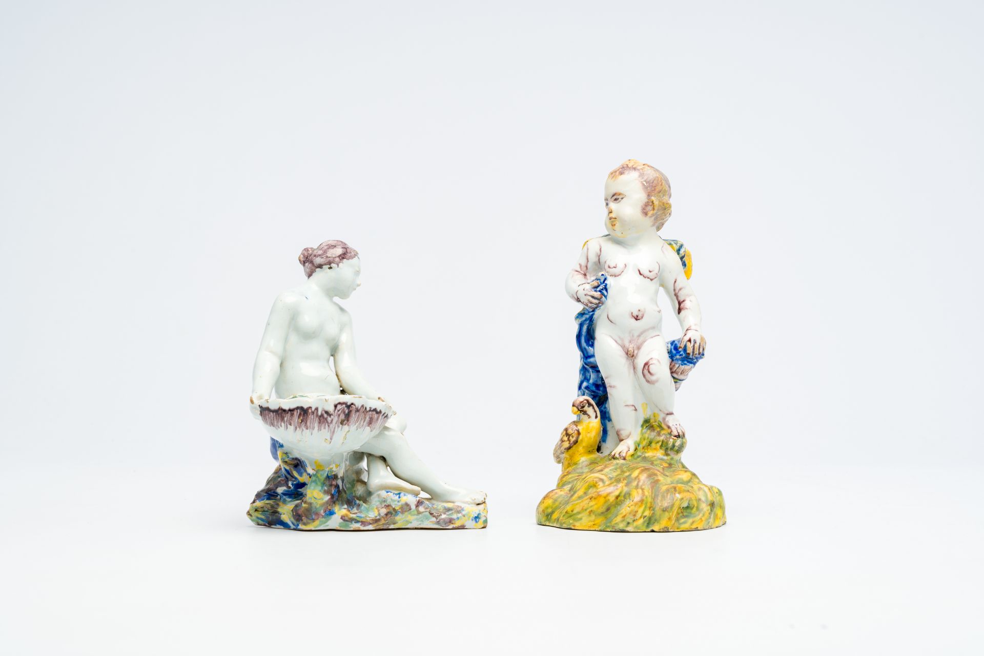 A polychrome 'putto and bird' faience sculpture and a 'lady with a shell' salt cellar, Delft or Brus - Image 2 of 7