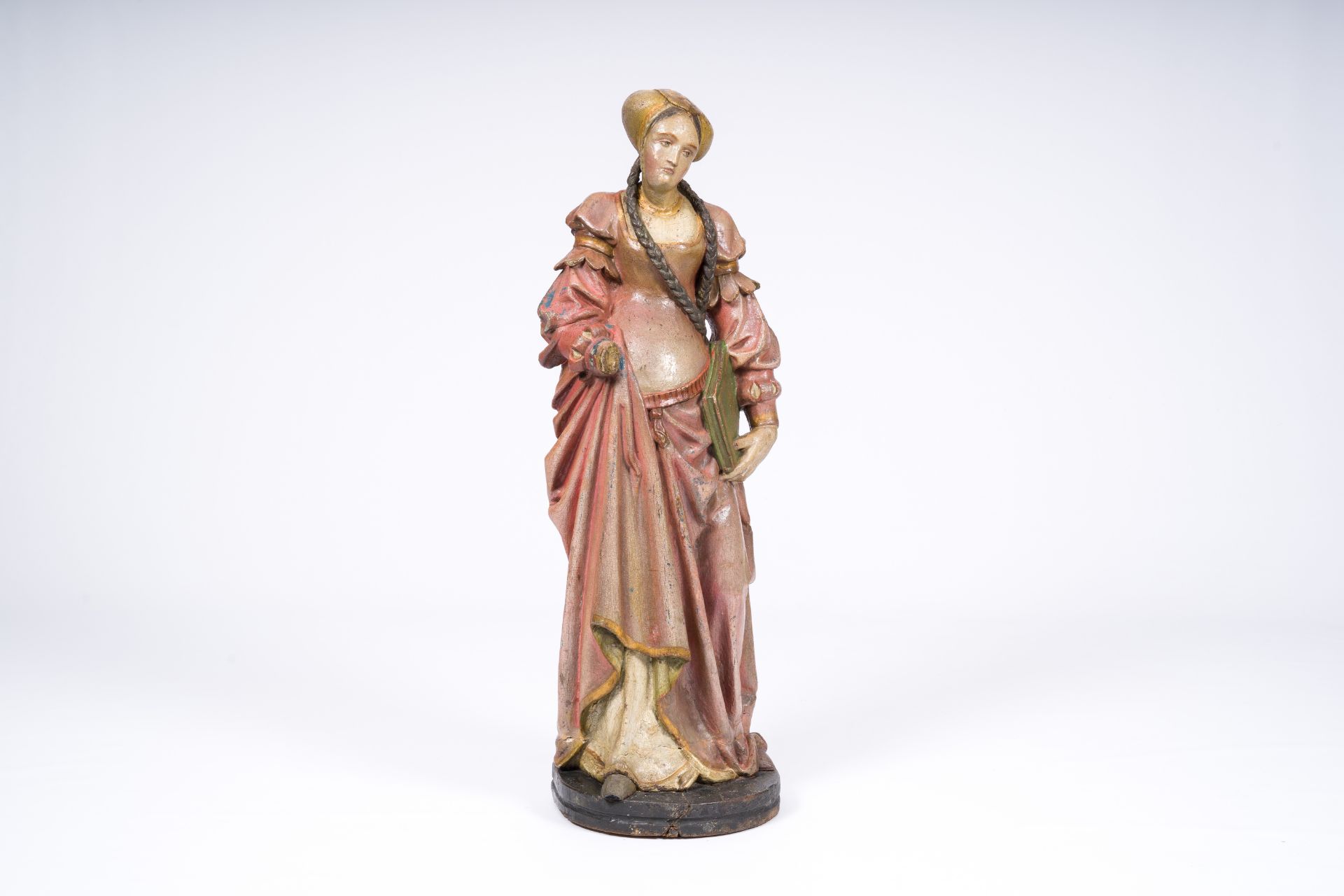 A German carved and polychrome painted wood 'noble lady with a book' figure, probably 16th C. and la