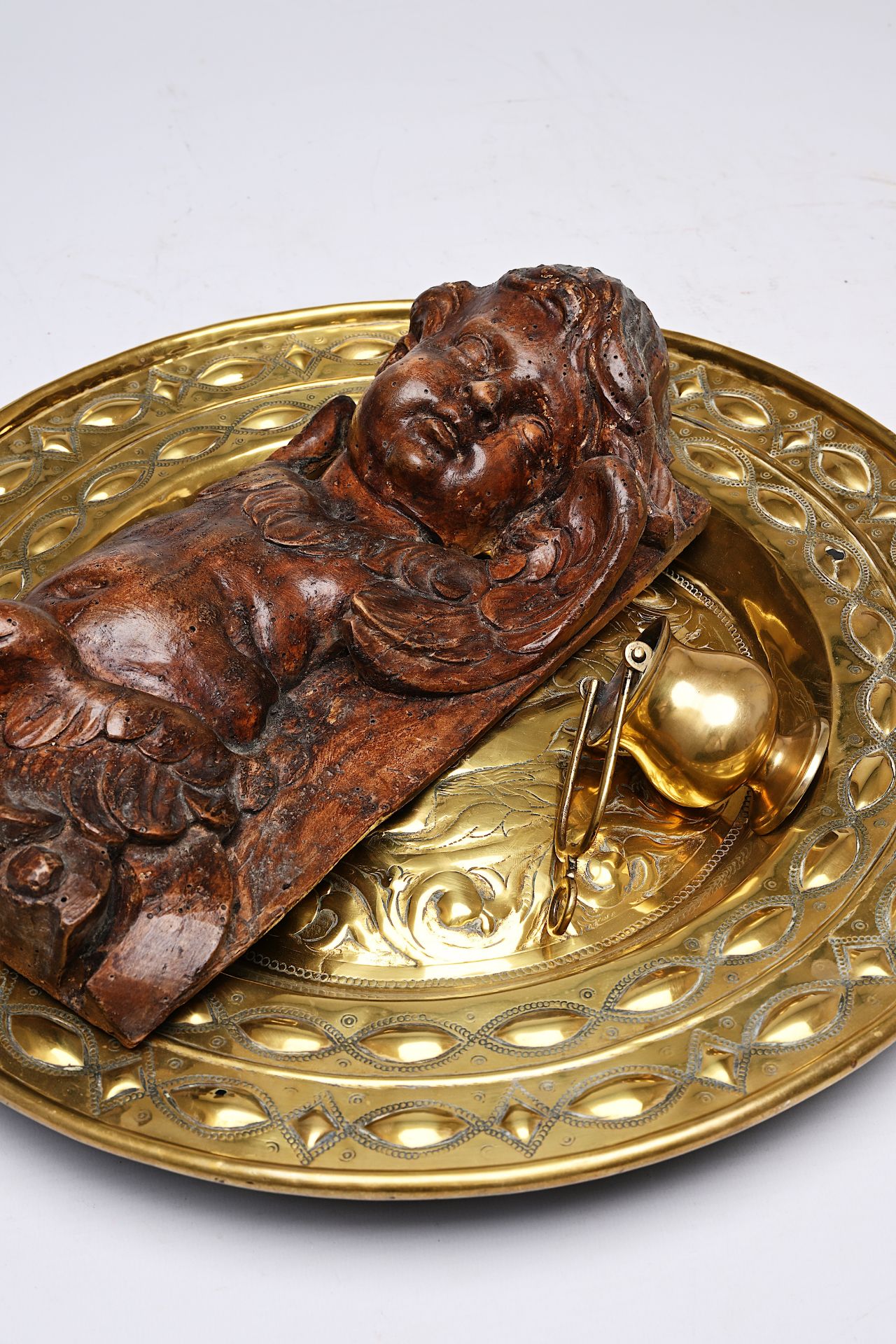 A German brass 'Adam and Eve' alms dish, a holy water font and a carved wood putto, 17th/18th C. - Image 4 of 4